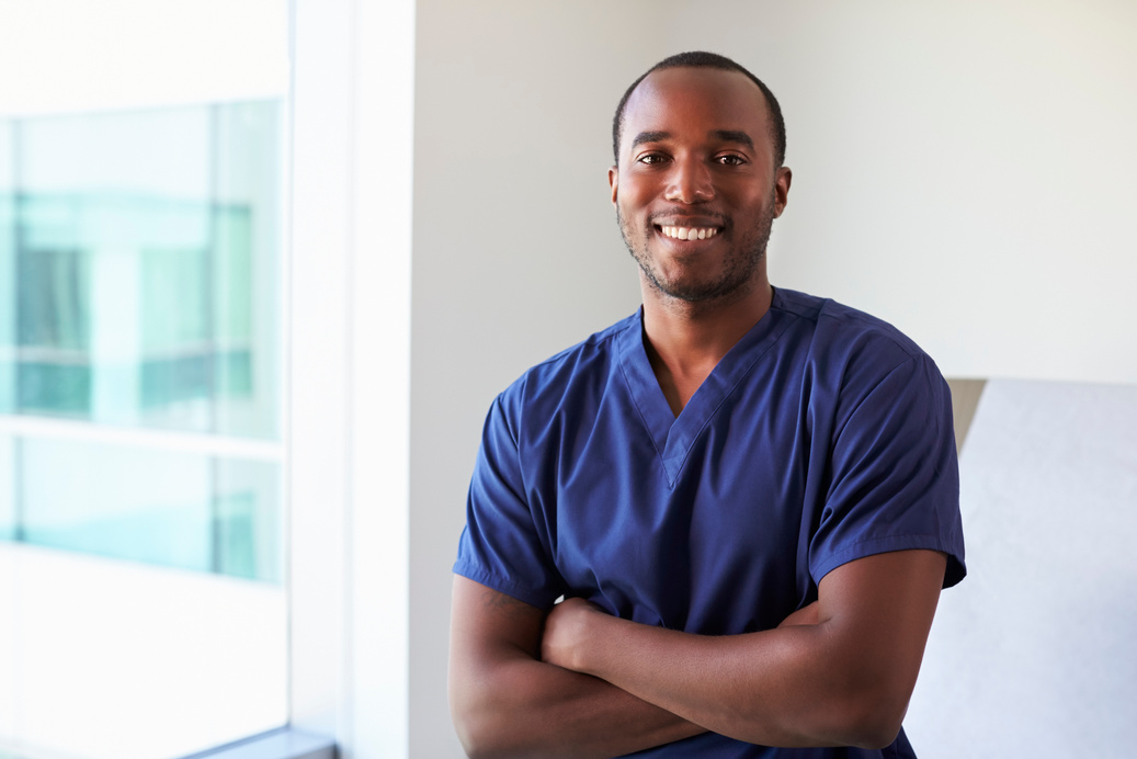 Portrait of Male Nurse Wearing Scrubs in Exam Room